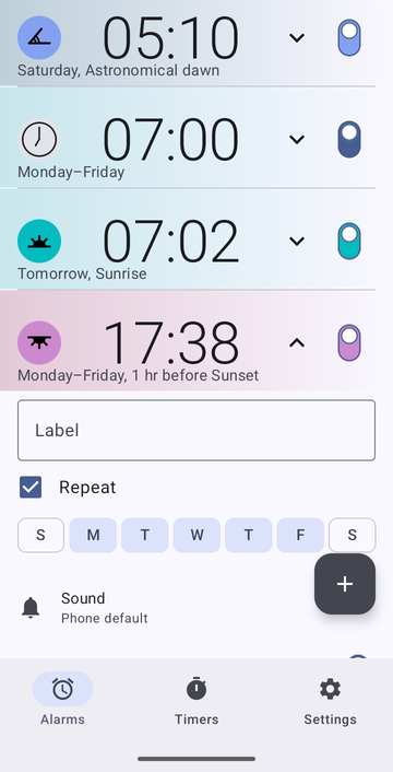 An open alarm card for 17:38, Monday to Friday, 1 hr before Sunset: an empty Label field, Repeat with Monday to Friday selected, Sound set to Phone default, and Vibrate on. The card carries on below the edge of the image.